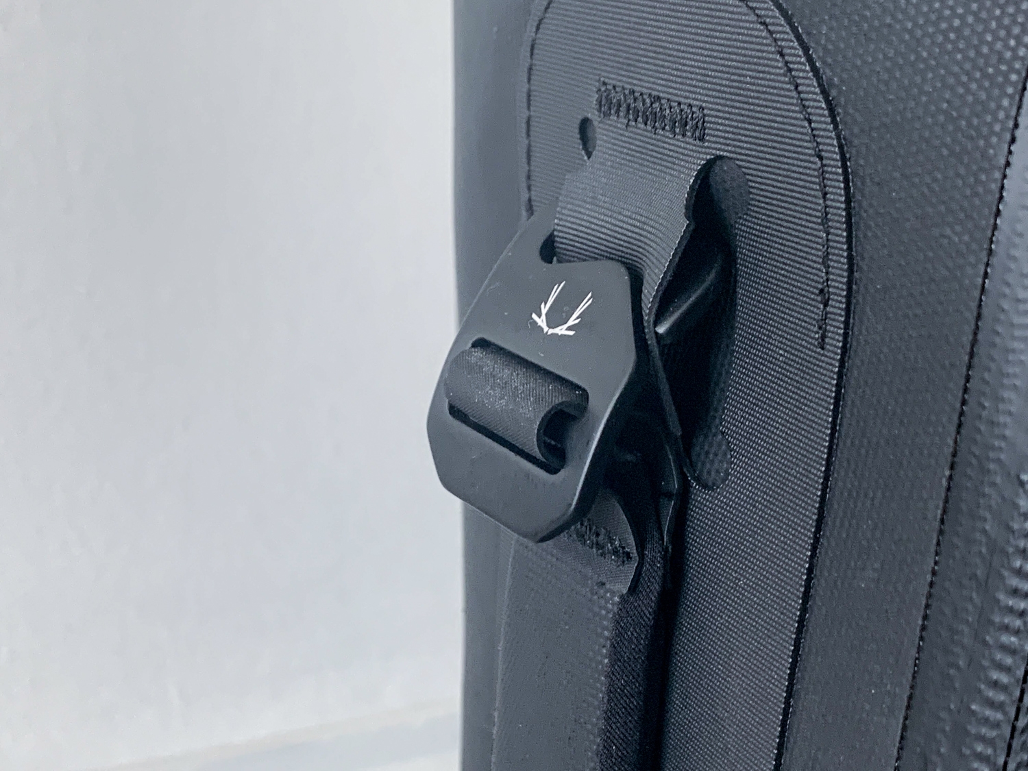 Minimal branding completes the look of this black minimalist backpack.