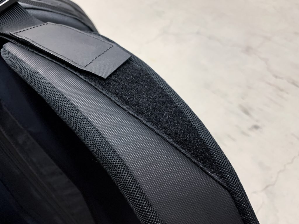 The velcro takes a little away from the clean black minimalist backpack look.